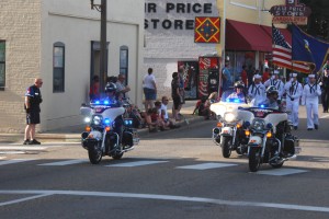 Police officers maintaining peace in a city 4th of July Independence Day parade.