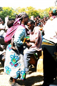A baby on the back of a woman who was  dancing the Chiwoda at the Lundazi Agricultural Show in 1996. Zambian babies experience a lot of excitement and may be that's why they don't cry.