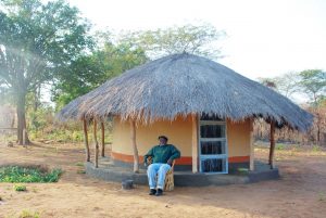 Mwizenge Tembo in front of his village hut.